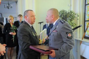 przewodniczący rady miasta Gniezna gratuluje policjantowi