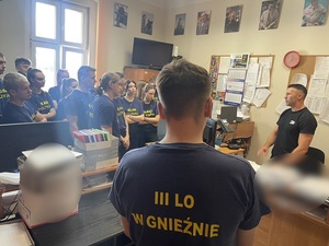 Uczeń stoi tyłem z napisem klasa policyjna.