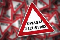 plakat z napisem &quot;Uwaga oszustwo&quot;